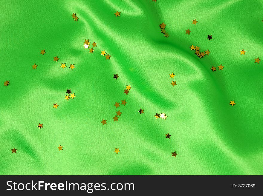 Green satin with golden stars, great celebration background. Green satin with golden stars, great celebration background