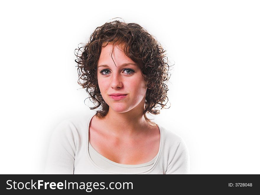 Head shot of curly-haired teenage girl with a half-smile, looking at camera. Shot against white background. Head shot of curly-haired teenage girl with a half-smile, looking at camera. Shot against white background