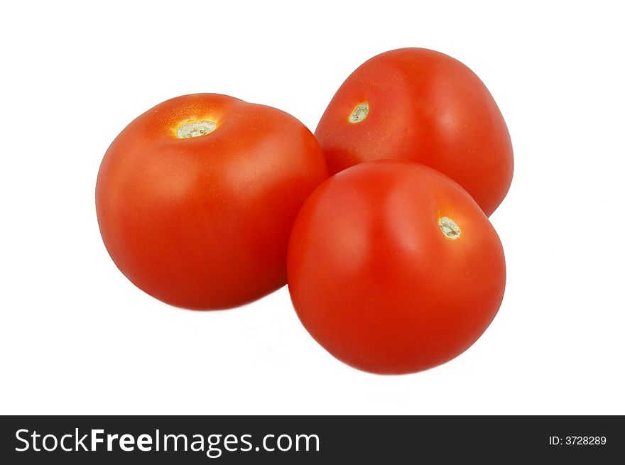 Three juicy red tomatoes isolated on white