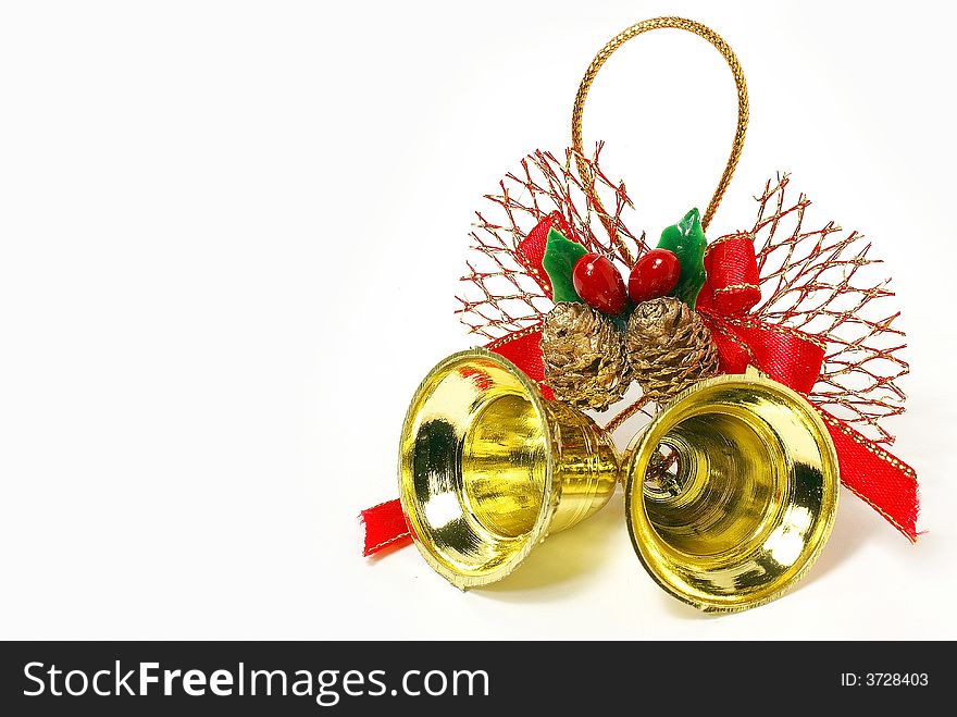 Isolated golden bells with red ribbon and bow against white background. Isolated golden bells with red ribbon and bow against white background