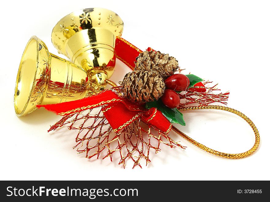 Isolated golden bells with red ribbon against white