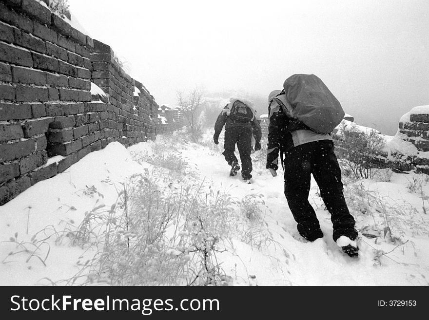 Hikers on The great wall of China after snowfall.Beijing,China.Black and White photo.