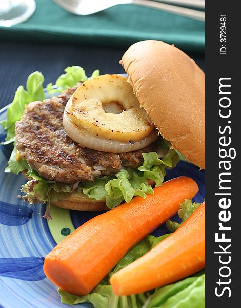 Healthier homemade grilled burger with carrots and plenty vegetables