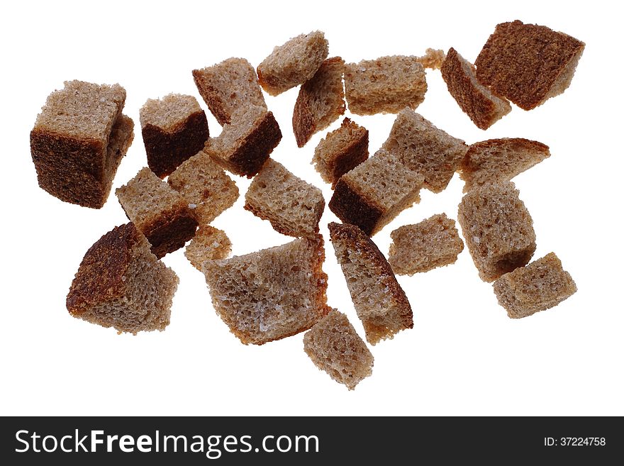 Photo of small dry slices of rye bread with salt for broth on a white background. Photo of small dry slices of rye bread with salt for broth on a white background