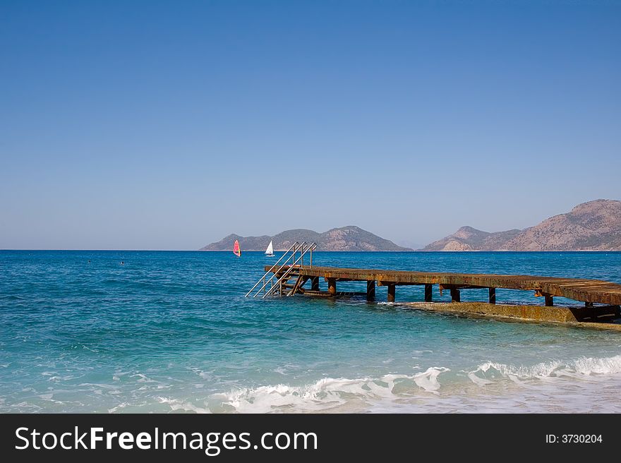 Photo of planked footway goes far in the sea. Photo of planked footway goes far in the sea