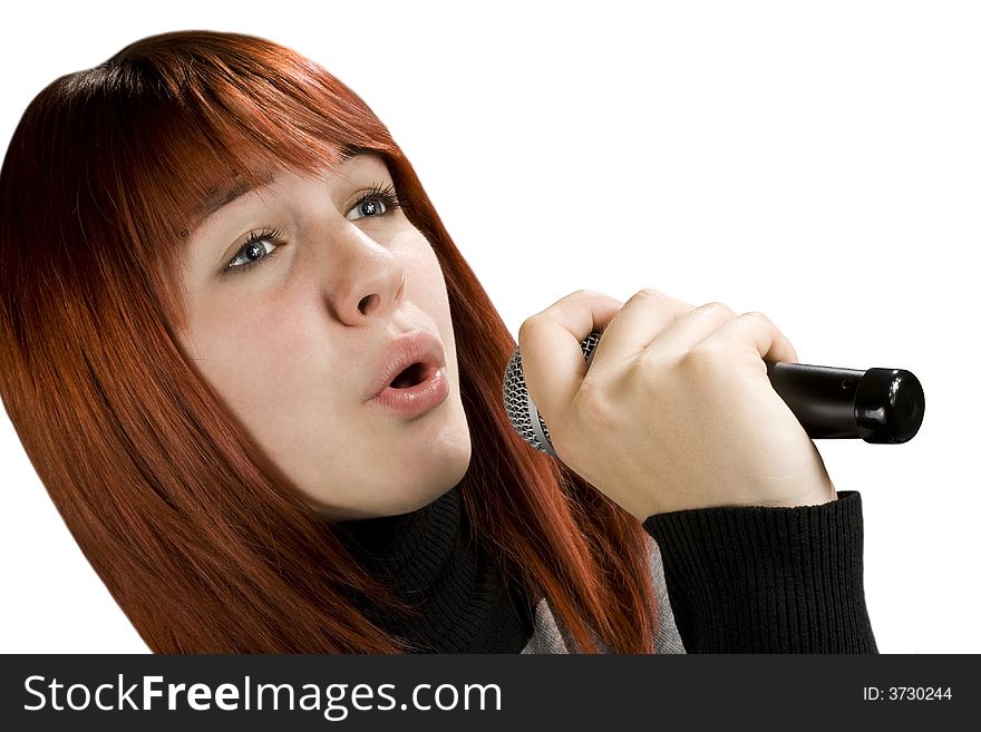 Girl using microphone, beautiful redhead with blue eyes. Studio shot. Girl using microphone, beautiful redhead with blue eyes. Studio shot.