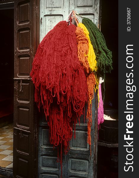 Fresh dyed wool hung out in street to dry. Fresh dyed wool hung out in street to dry