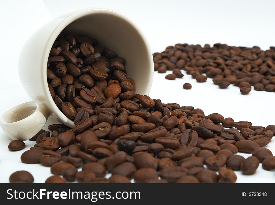 Cup of beans coffee on a white background