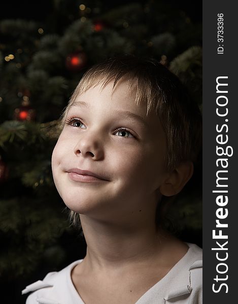 Smiling boy near a new year tree with decorations. Smiling boy near a new year tree with decorations