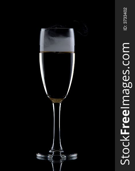 Glass of white wine isolated over black background, with smoke. Glass of white wine isolated over black background, with smoke