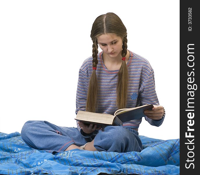 Girl in the home clothes, reading in bed. Girl in the home clothes, reading in bed