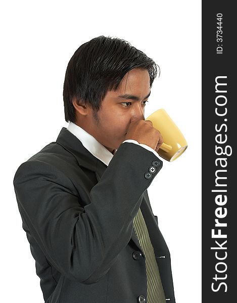 A man drinking coffee from a cup. A man drinking coffee from a cup