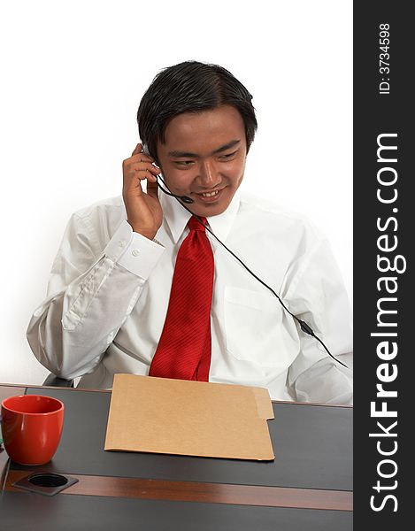 A man sitting behind an office desk. A man sitting behind an office desk