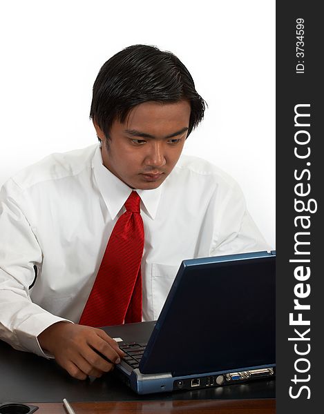 A man working on his laptop over a white background. A man working on his laptop over a white background