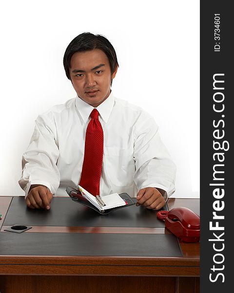A man sitting behind an office desk. A man sitting behind an office desk