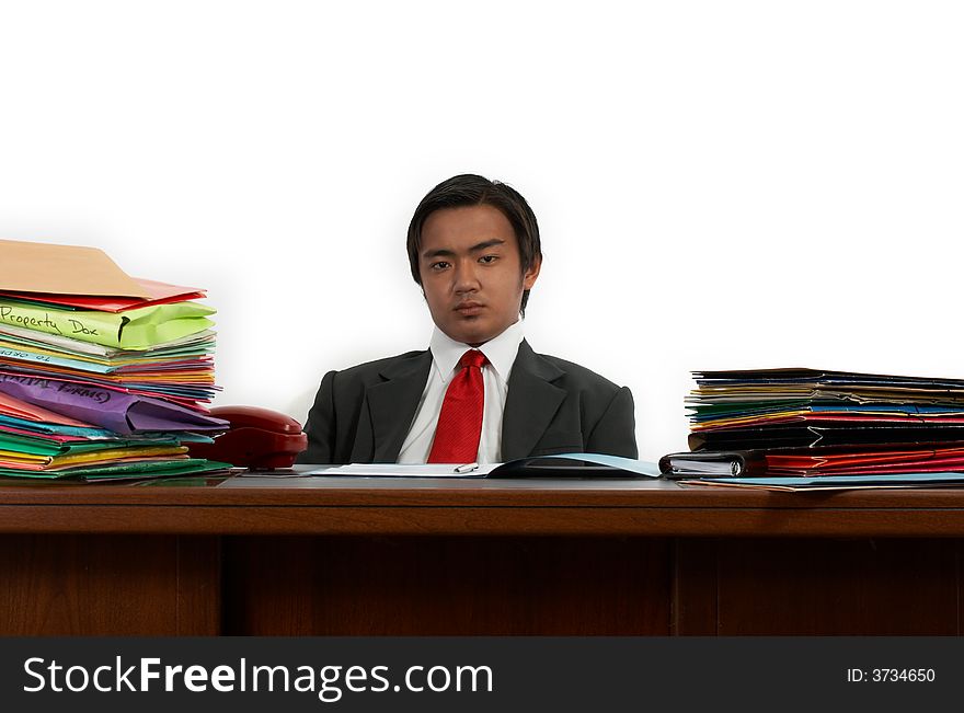 A man sitting behind his office desk. A man sitting behind his office desk