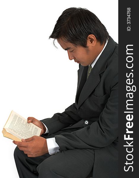 A man sitting and reading a book over a white background