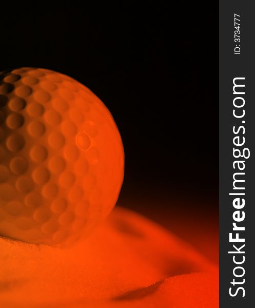 Close-up of golf ball with orange lighting effect. Close-up of golf ball with orange lighting effect.