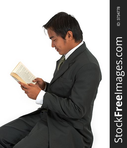 A man sitting reading a book over a white background