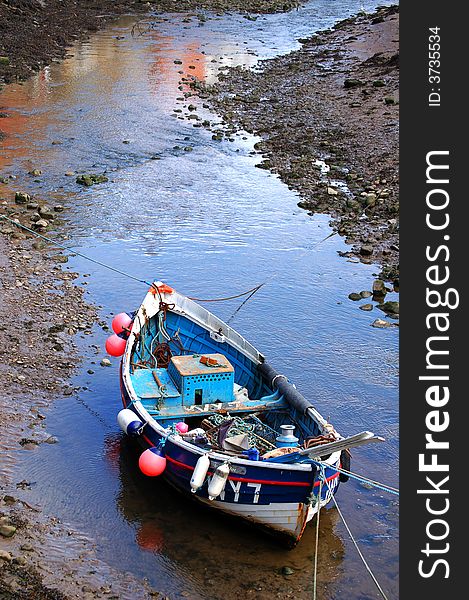 Small fishing boat moored in a creek. Small fishing boat moored in a creek