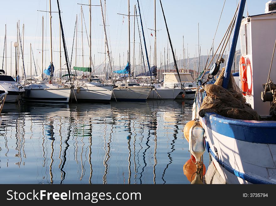 Boat reflections in toulon port, france