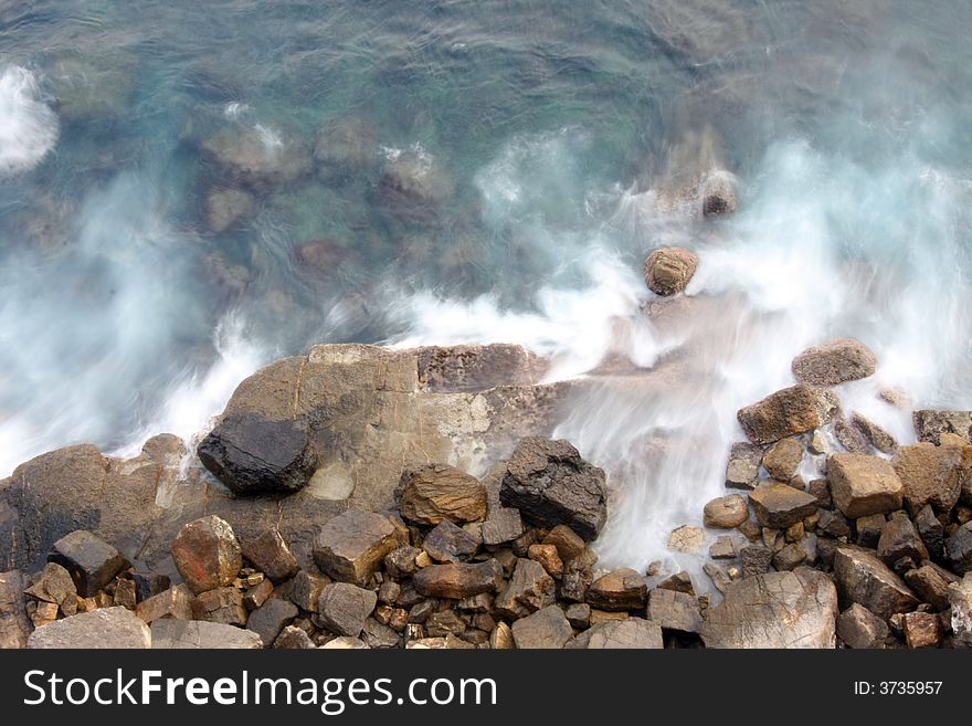 Long exposure of waves crashing against rocks. Long exposure of waves crashing against rocks
