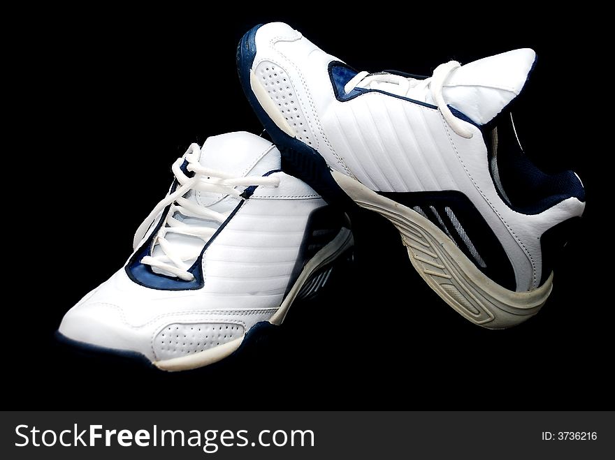White sport shoes image on the black background