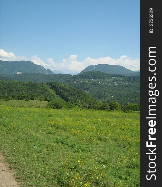 Hi mountain meadow on background blue sky. Hi mountain meadow on background blue sky