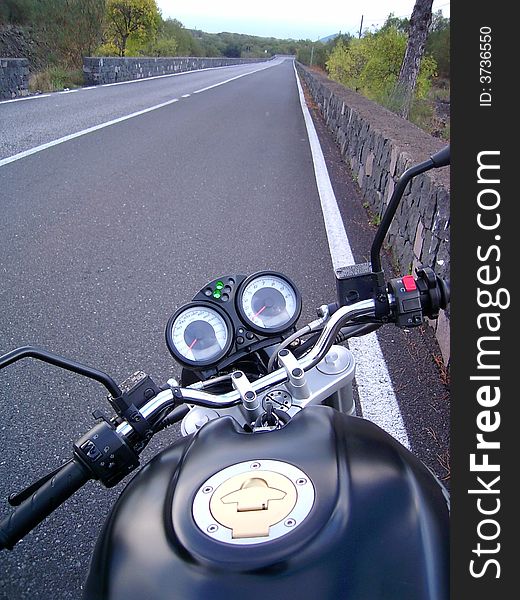 Lone motorbike on a small road in the Etna volcan, Sicily. Lone motorbike on a small road in the Etna volcan, Sicily