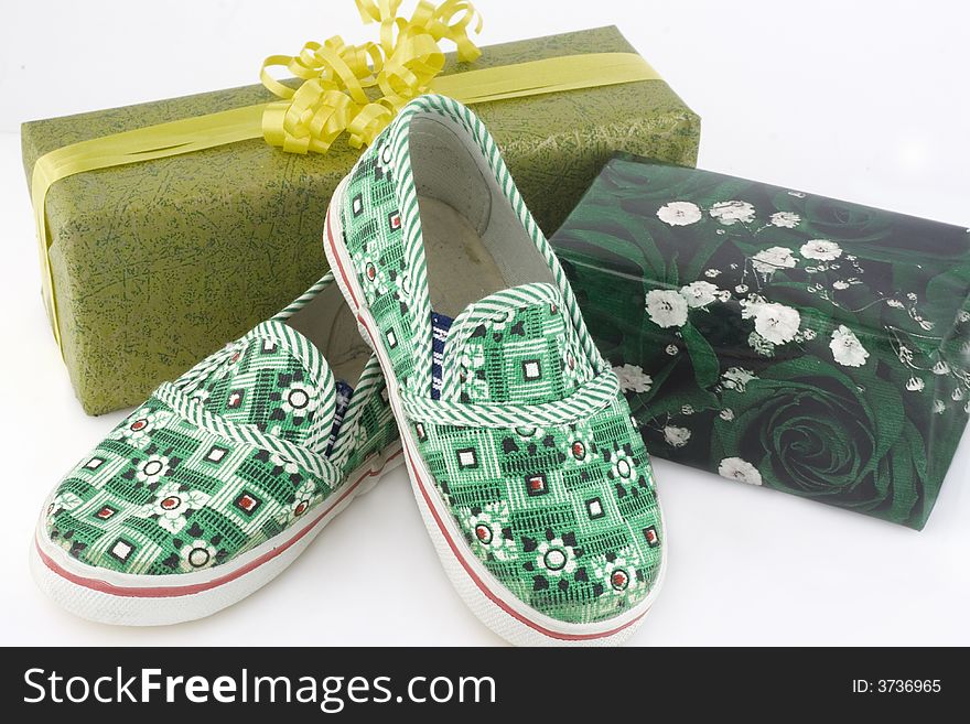 Two gift boxes and green shoes