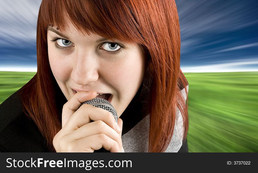 Happy redhead girl singing karaoke on a microphone.

Studio shot. Happy redhead girl singing karaoke on a microphone.

Studio shot.