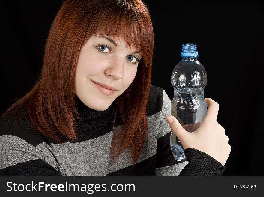 Redhead girl holding water bottle