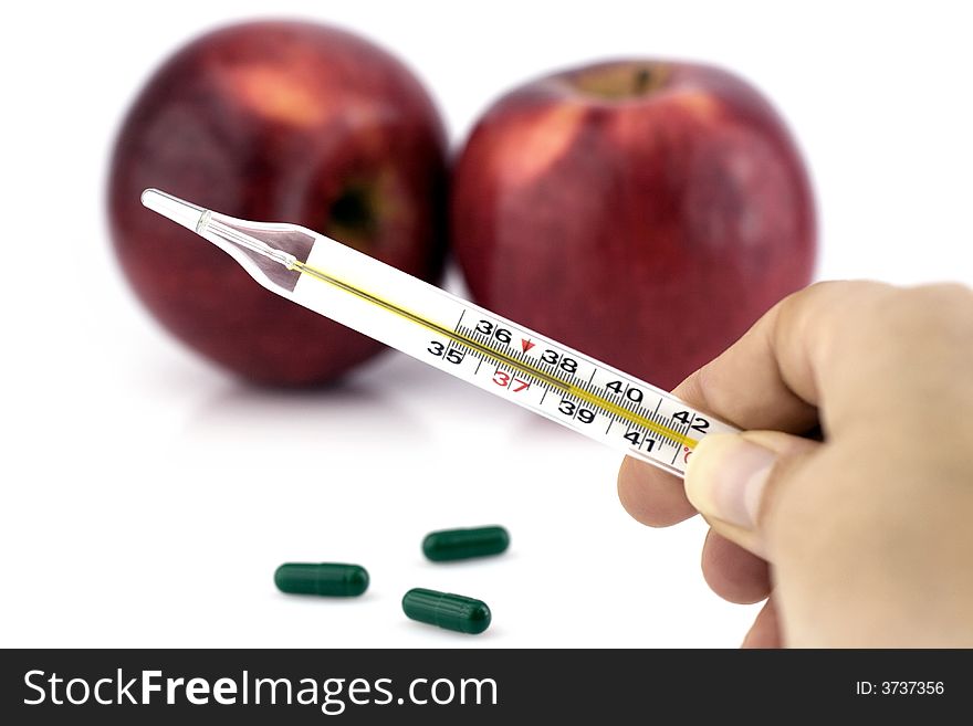 Hand holding thermometer, and two apples on white background. Hand holding thermometer, and two apples on white background