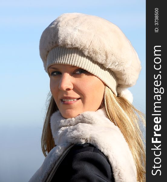 Blond girl in a fur hat and a scarf. Blond girl in a fur hat and a scarf