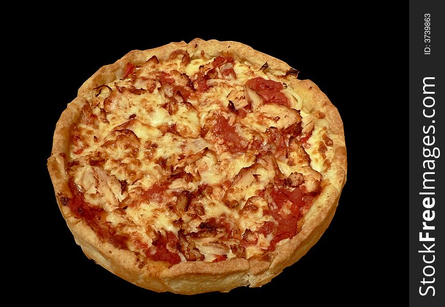 Photo of a chicken topped thick crust pizza isolated over a black background via clipping path. Photo of a chicken topped thick crust pizza isolated over a black background via clipping path