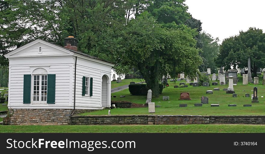 Hillside cemetary with old building and tombstones