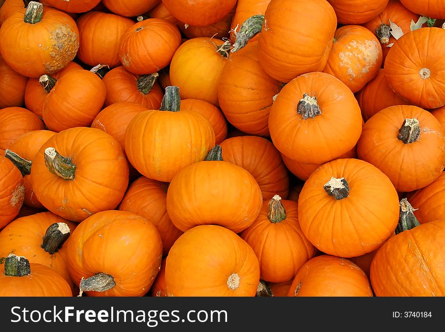 A large pile of pumpkins looking at from above