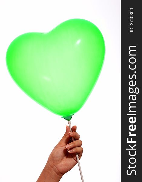 A hand holding a green balloon on white background. A hand holding a green balloon on white background