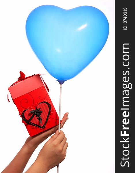 Hands holding a heartshape balloon and a red gift box