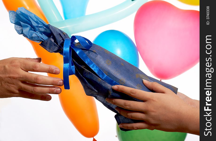 A hand giving gift wrap in blue color. A hand giving gift wrap in blue color