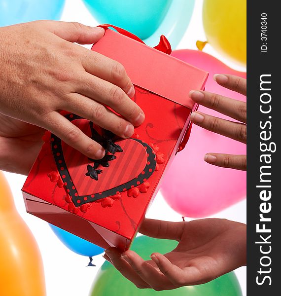 A hands giving gift in red color box. A hands giving gift in red color box