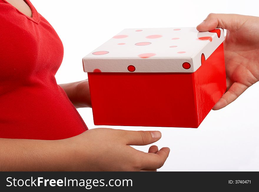 A hands holding a box in a red color. A hands holding a box in a red color