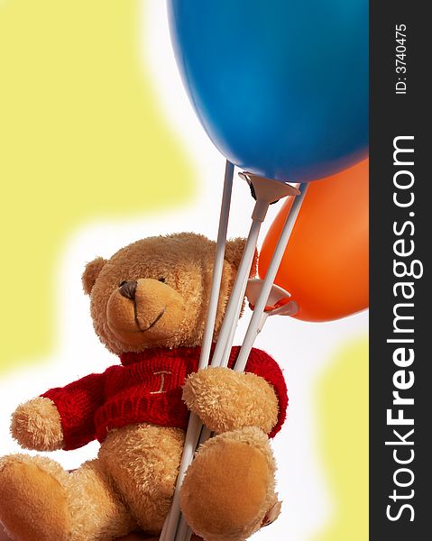 Teddy bear holding a bunch of colorful balloons. Teddy bear holding a bunch of colorful balloons