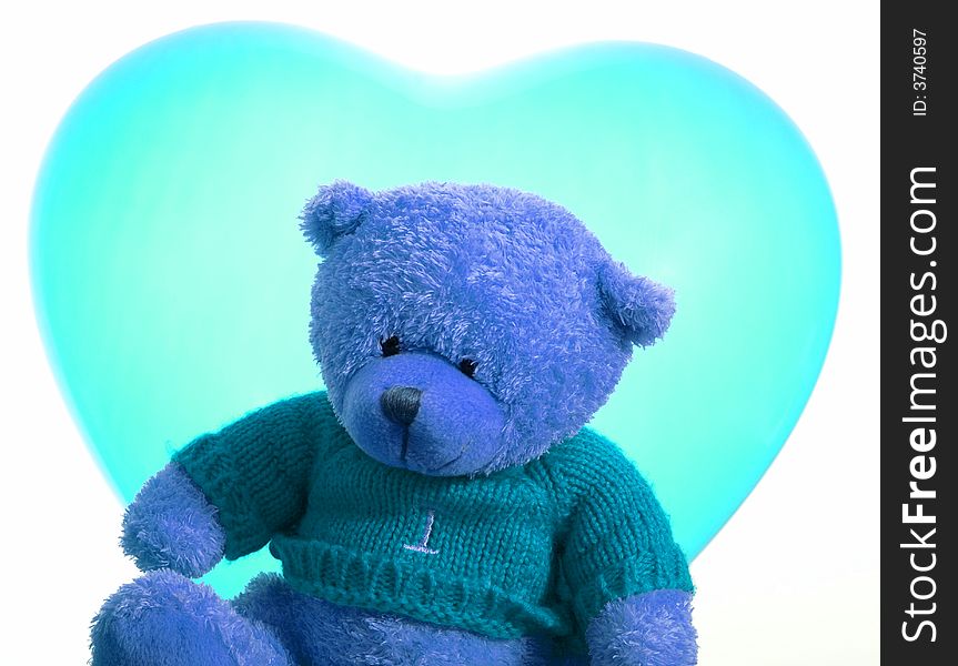 A cute teddy bear and a heart shape balloon