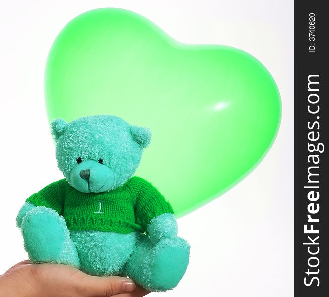 A cute teddy bear and a heart shape balloon