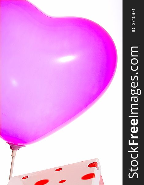 Pink balloon and a polkadot red gift box