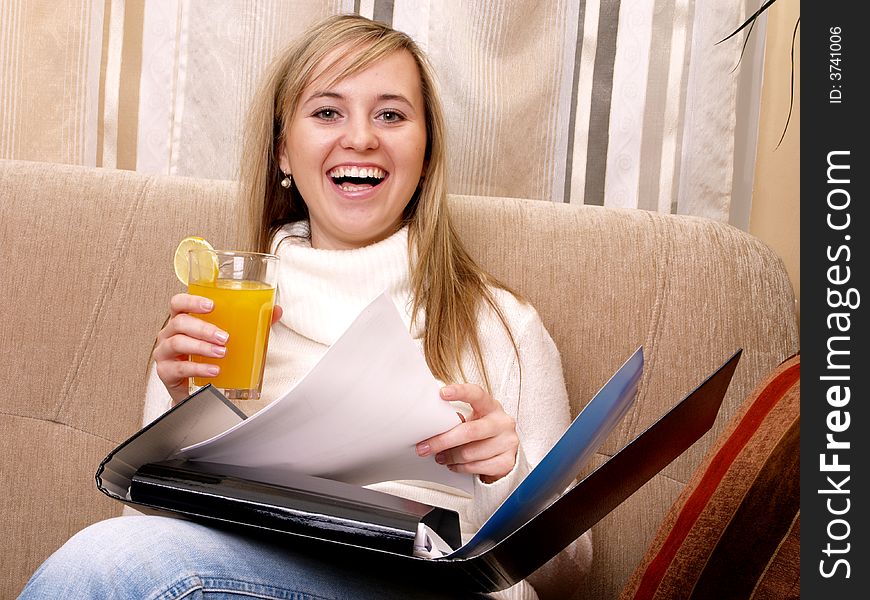 Smiling woman with documents and orange juice in her hand. Smiling woman with documents and orange juice in her hand.