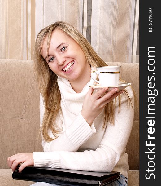 Smiling young woman after work. With coffee and folder. Smiling young woman after work. With coffee and folder.