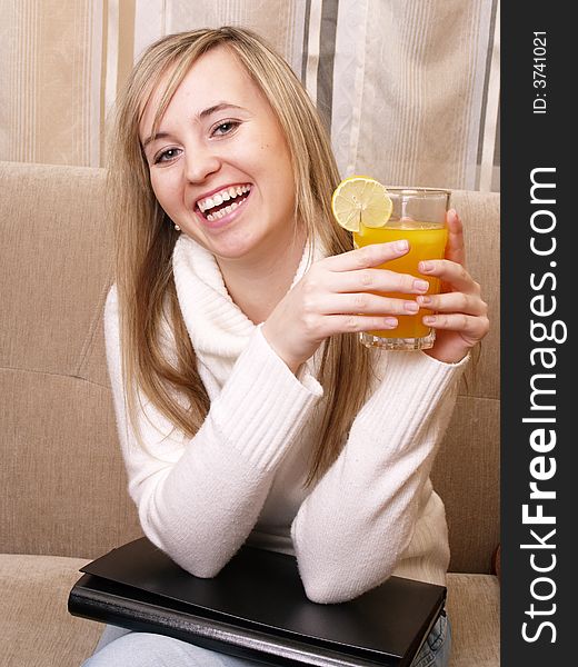 Smiling female student after lecture. With orange juice and folder. Smiling female student after lecture. With orange juice and folder.