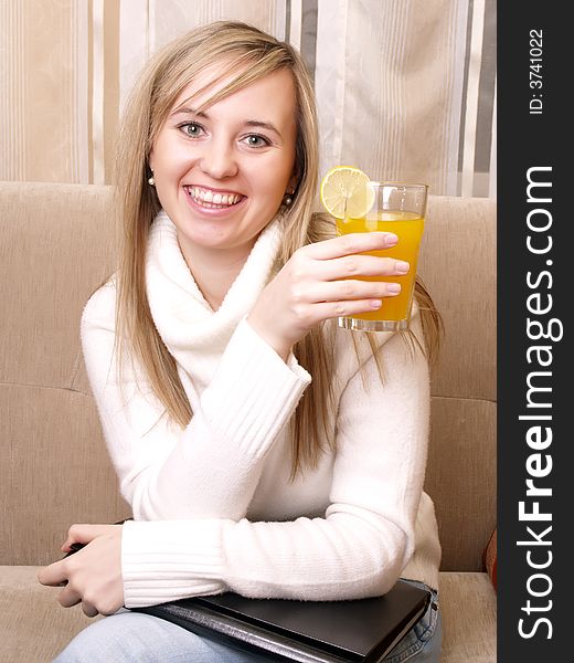 Smiling Young Woman On The Couch.